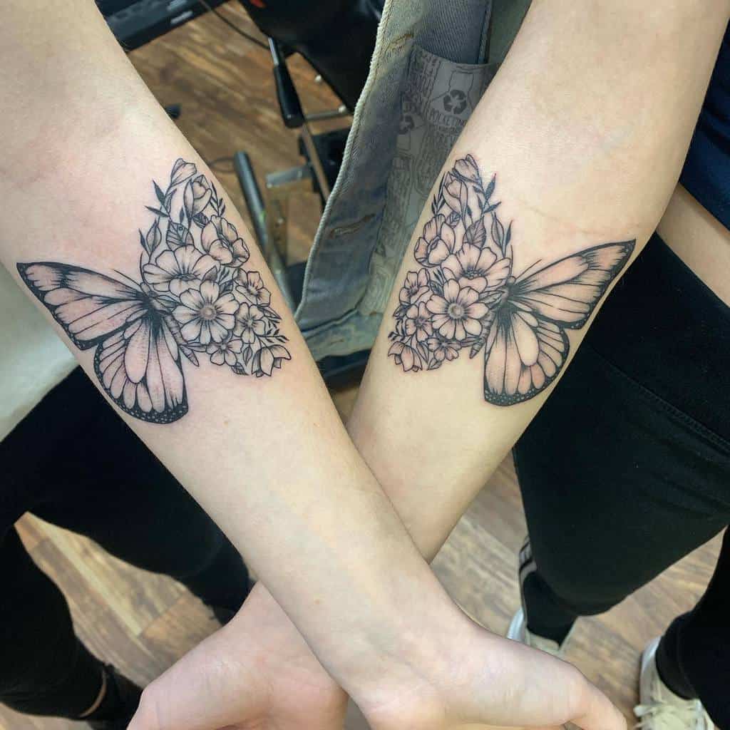 Matching sister tattoos on forearms featuring a half-butterfly with floral details, creating a complete design when placed together