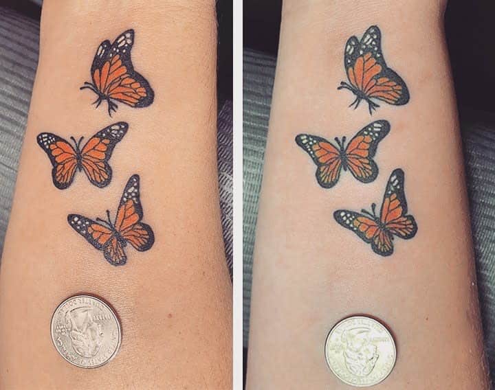 Delicate mother-daughter butterfly tattoos, with three butterflies in vibrant orange and black