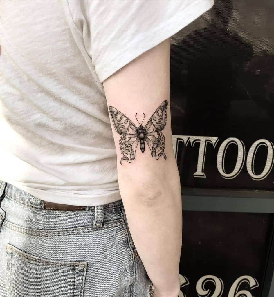 Butterfly tattoo on woman's inner uper arm