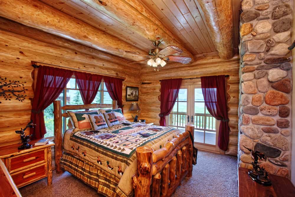 wood cabin bedroom with stone accents
