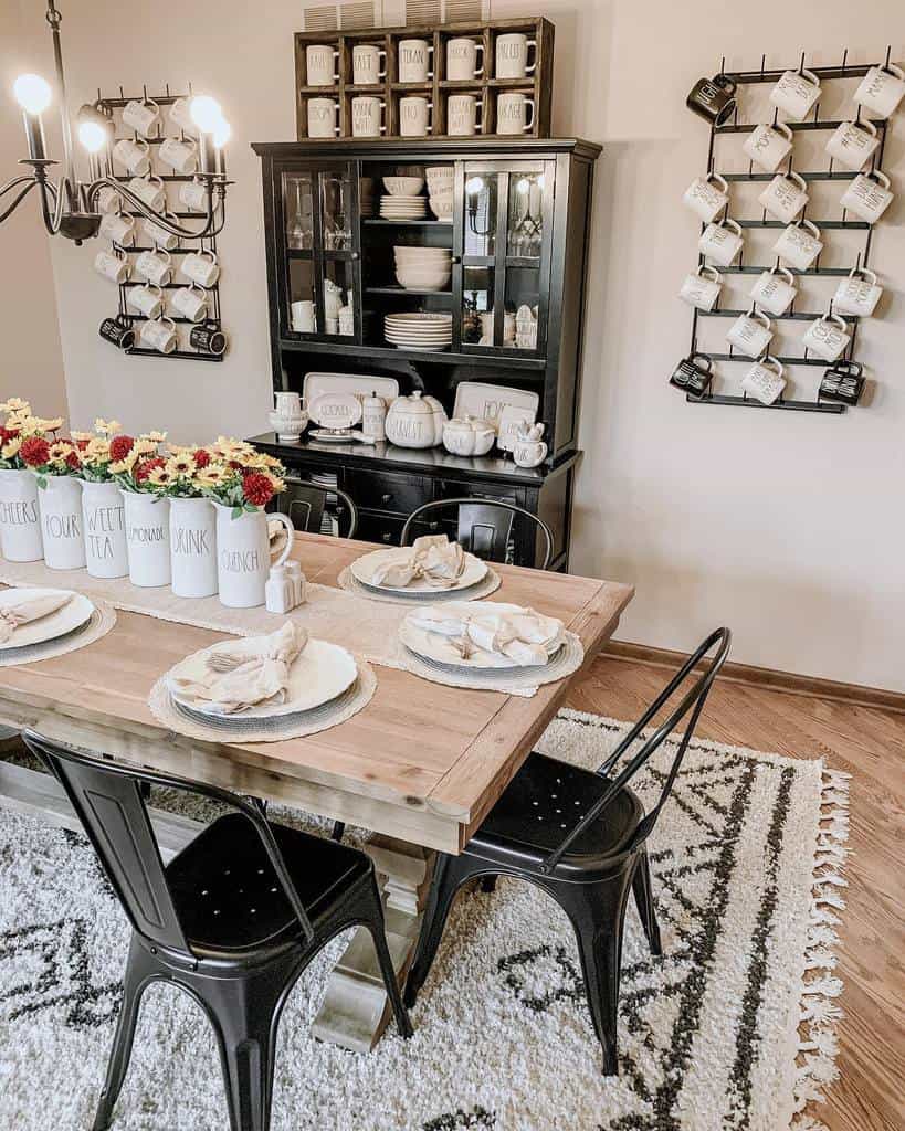 black cabinet dining room hanging mugs wall art wood table and black chairs 