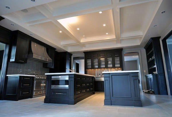 large kitchen with gray cabinets and two islands 