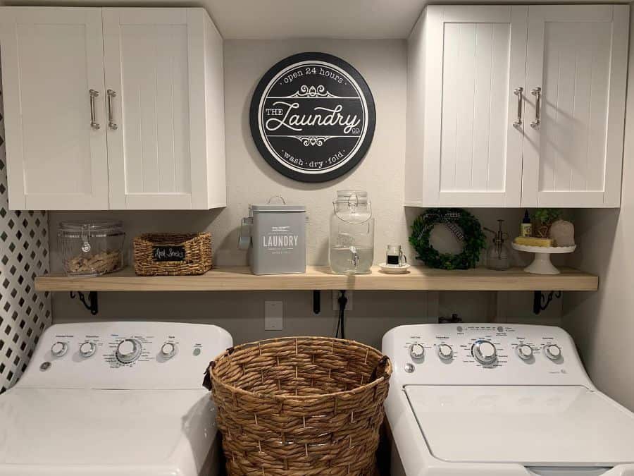 dual white cabinets above washer dryer laundry room