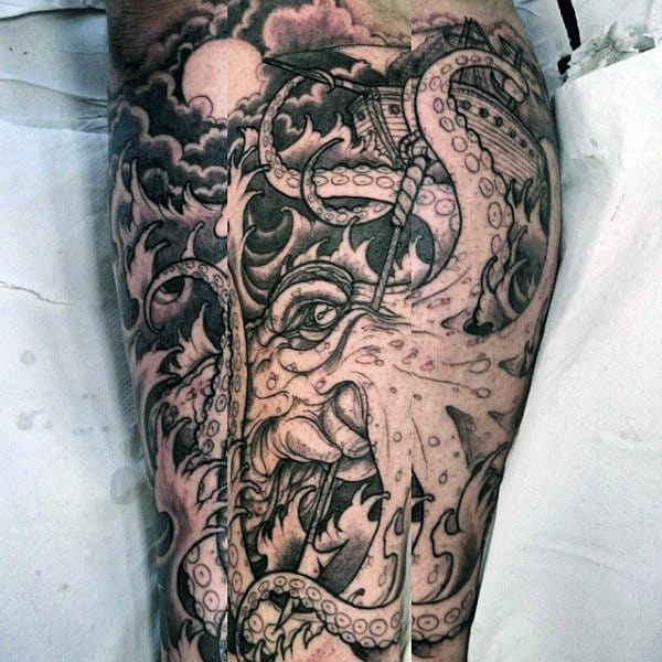 Detailed black and grey calf tattoo of a kraken with massive tentacles wrapping around a sinking ship under a stormy moonlit sky