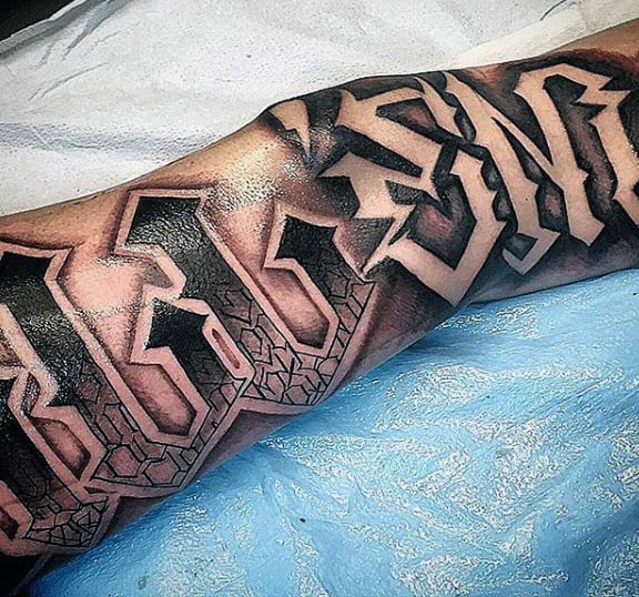 Bold calf tattoo featuring 3D-style lettering with intricate geometric patterns and heavy black shading for a striking effect
