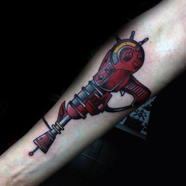 Bold and colorful Call of Duty Ray Gun tattoo on the forearm, featuring a vibrant red and black design with futuristic details.
