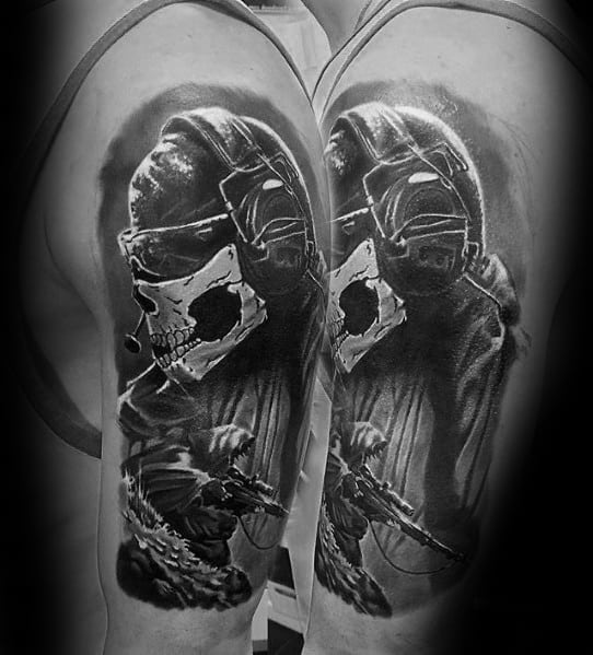 Realistic Call of Duty Ghost tattoo on the upper arm, featuring a masked soldier with a sniper rifle in detailed black and grey shading.