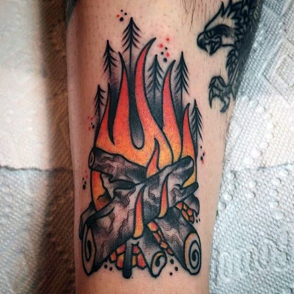 Bold neo-traditional campfire tattoo with burning logs, stylized flames, pine trees, and dotwork accents in red and black.