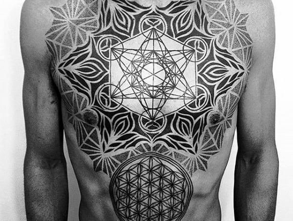 Man with intricate geometric tattoos covering his chest and upper abdomen