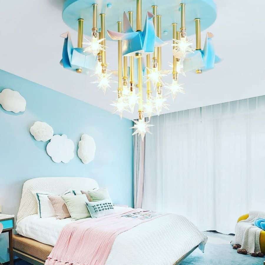 Children's bedroom with a star-shaped chandelier, cloud wall art, and pastel bedding