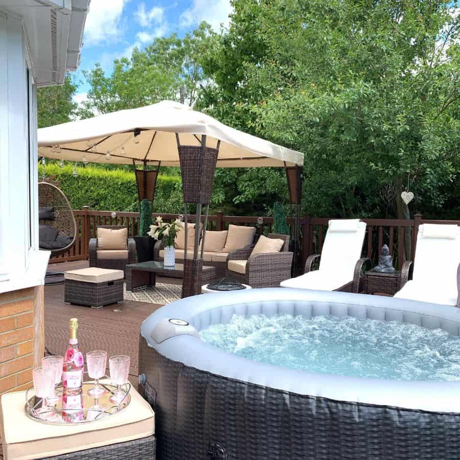 large backyard deck wicker table and chairs inflatable spa