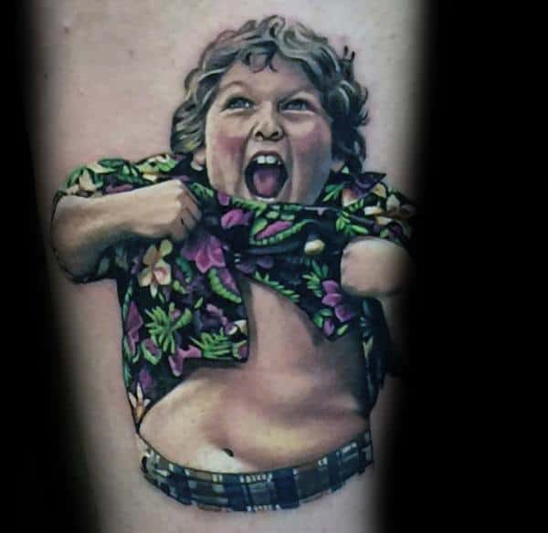 Realistic color tattoo of Chunk from The Goonies performing the Truffle Shuffle, wearing a vibrant Hawaiian shirt and plaid pants.