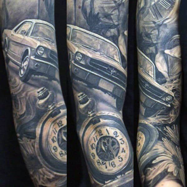 Tattoo sleeve with a classic car, pocket watch, and grayscale abstract elements