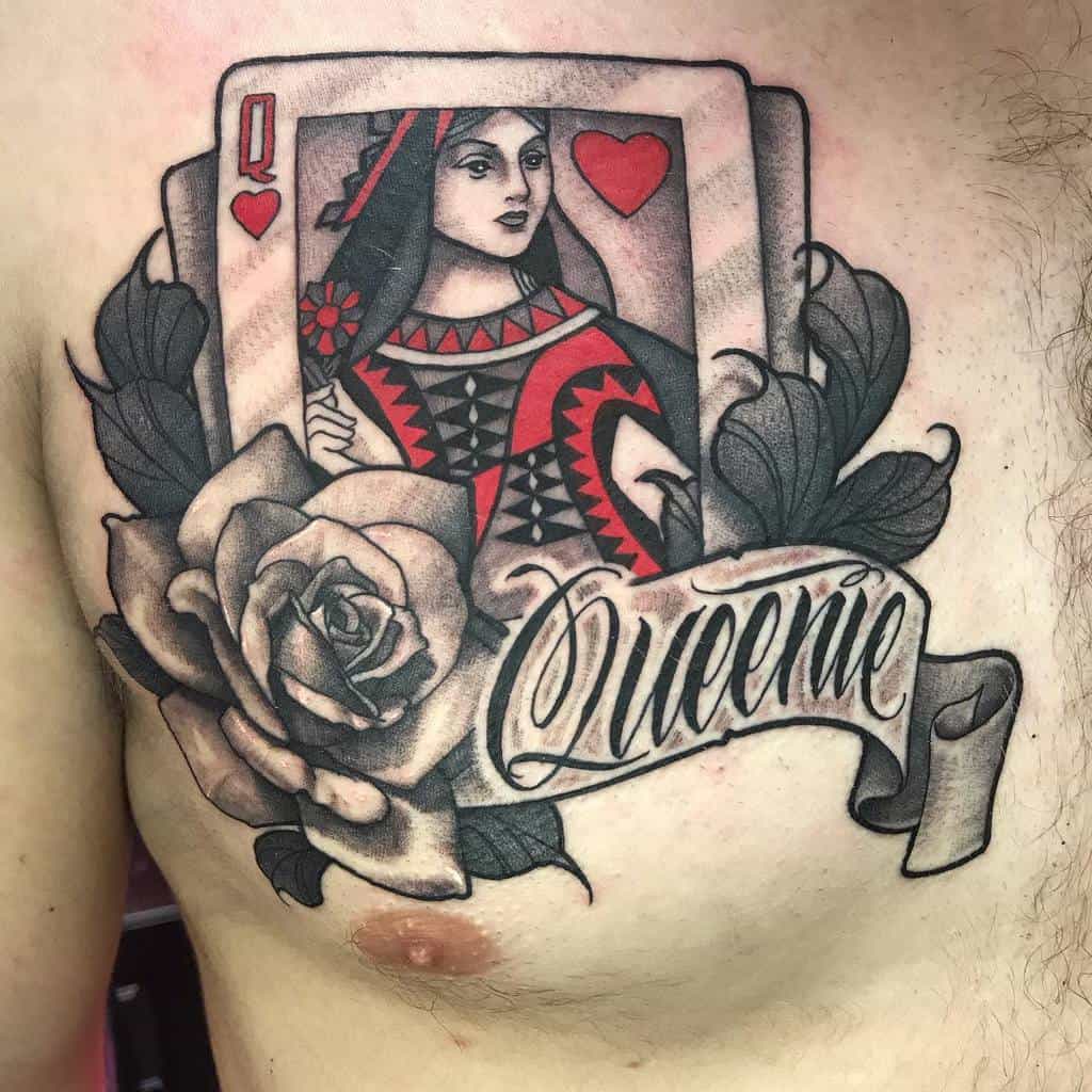Tattoo of a queen of hearts card with a rose and banner on the chest