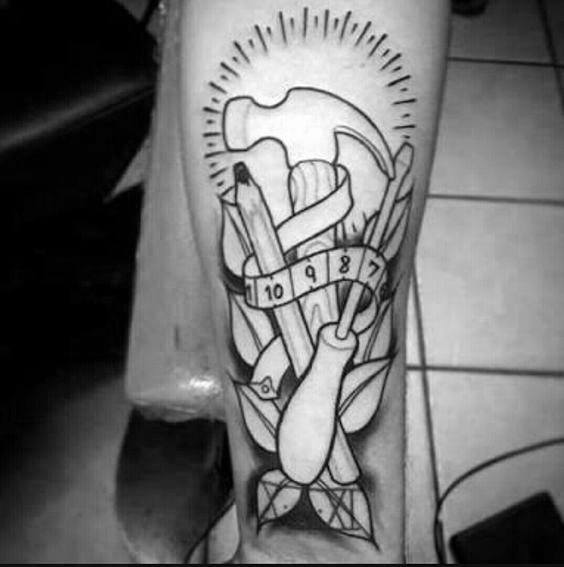 Black and gray tattoo featuring a hammer, pencil, screwdriver, and measuring tape with decorative elements, symbolizing craftsmanship and precision.