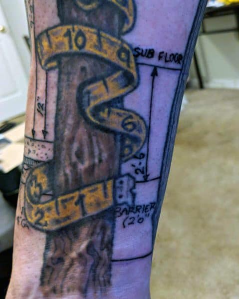 Tattoo of a wooden post wrapped in a yellow measuring tape, with blueprint-style markings, symbolizing precision, craftsmanship, and construction.