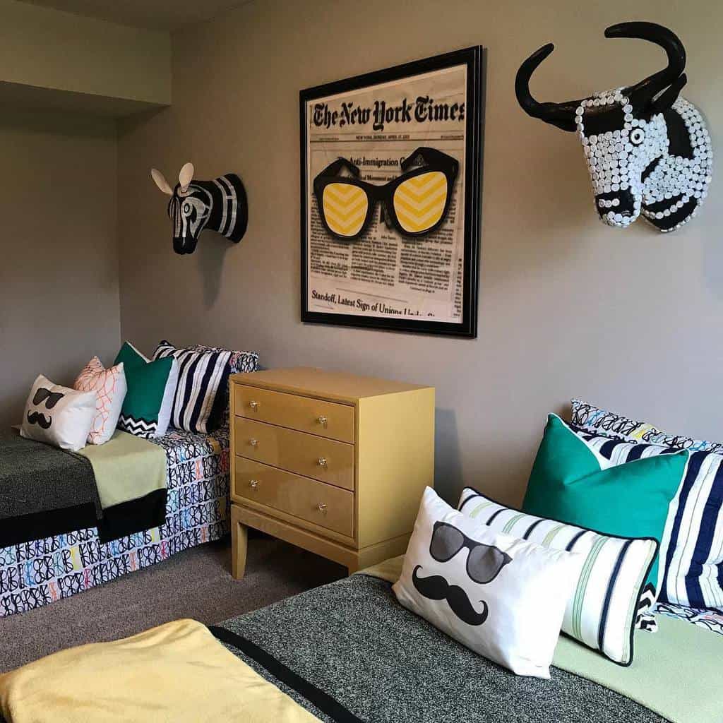 Twin children's bedroom with playful pillows, animal heads, and quirky wall art.