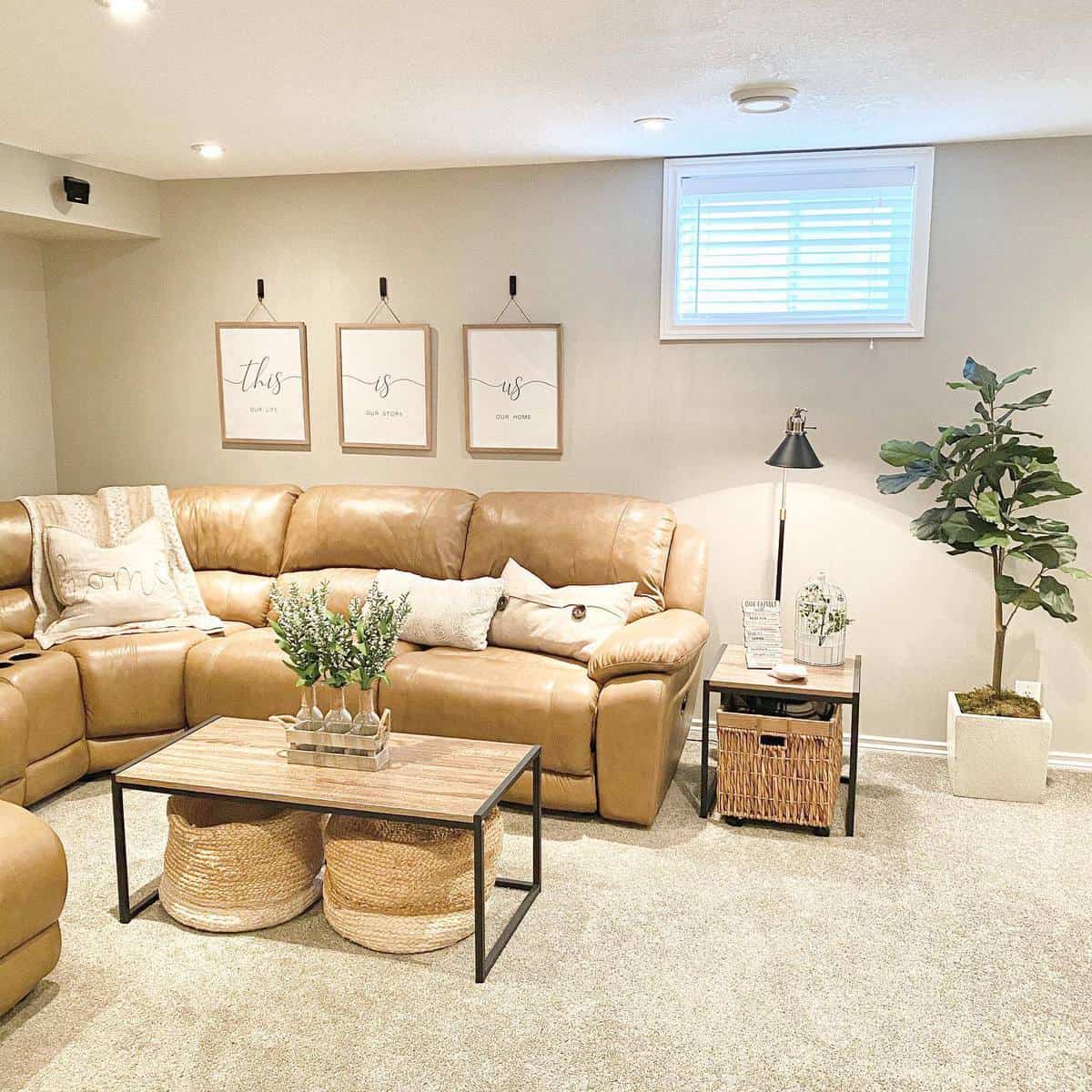 Simple living room with mustard leather sectional, decorative wall art, and neutral accents.