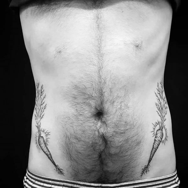 Symmetrical black ink carrot tattoos on both sides of the lower abdomen, featuring fine line detailing and leafy tops for a unique organic design.
