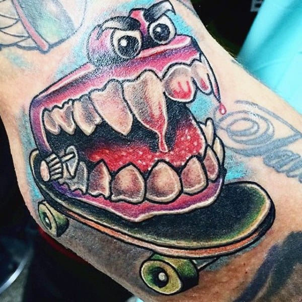 Cartoon Style Guys Tattoo Of Teeth Riding Skateboard