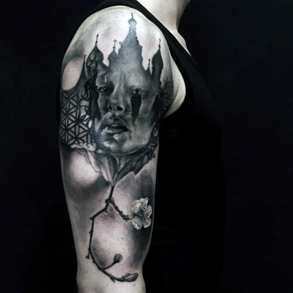 Half-sleeve tattoo featuring a surreal portrait of a woman blended with a gothic castle, geometric patterns, and a delicate cherry blossom branch