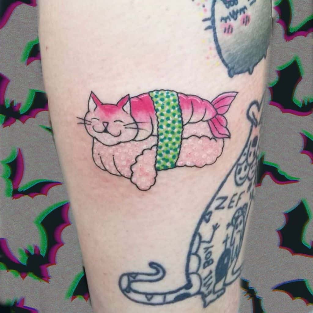 A colorful tattoo of a happy cat merged with a sushi roll, wrapped in seaweed, blending cute and humorous elements in a playful design.