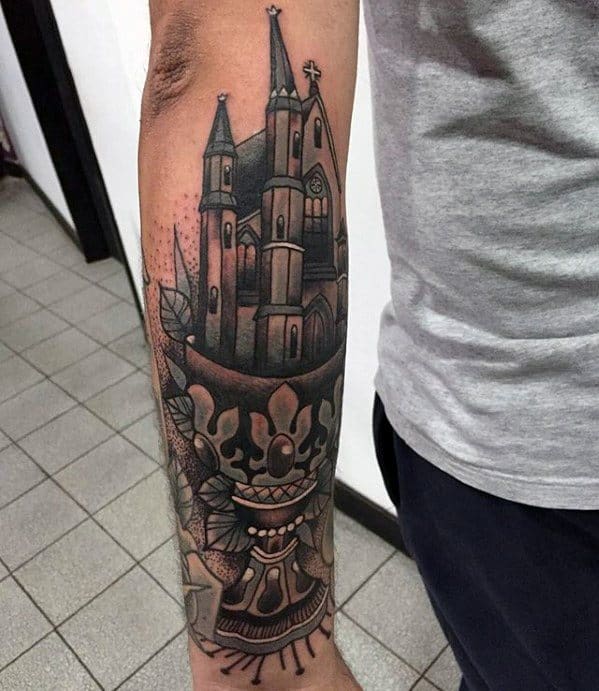 Forearm tattoo of a gothic cathedral rising from an ornate chalice, with sharp spires and dotwork shading for depth and texture.