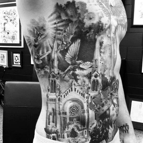 Full side torso tattoo featuring a gothic cathedral, flying doves, dramatic clouds, and a crowned figure for a spiritual, powerful look.