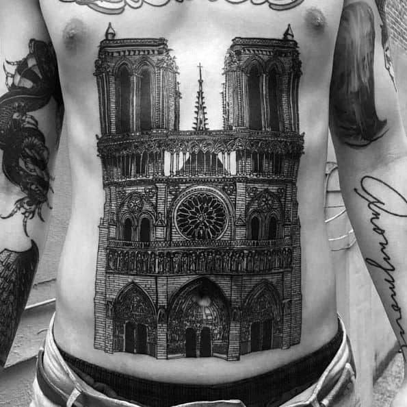 Detailed chest and stomach tattoo of the Notre-Dame Cathedral, showcasing its iconic towers, rose window, and gothic arches.