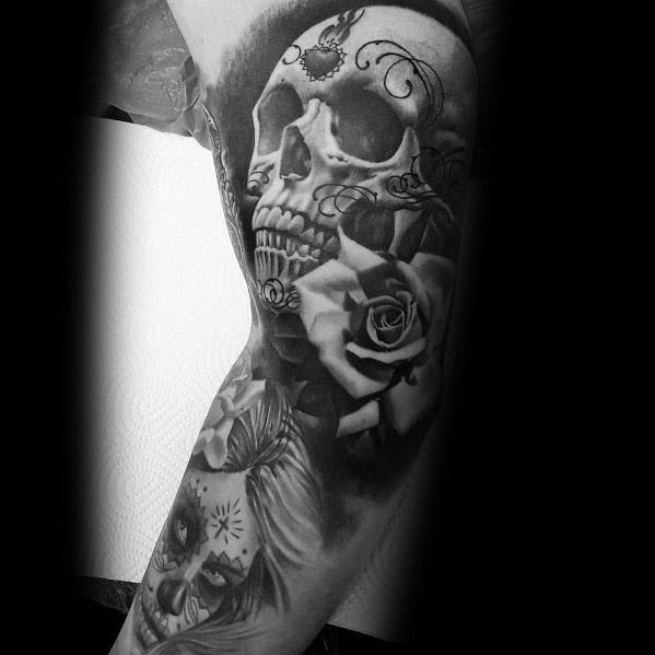La Catrina tattoo featuring a skull with ornate details, a rose, and a smaller portrait of a woman with sugar skull makeup below.