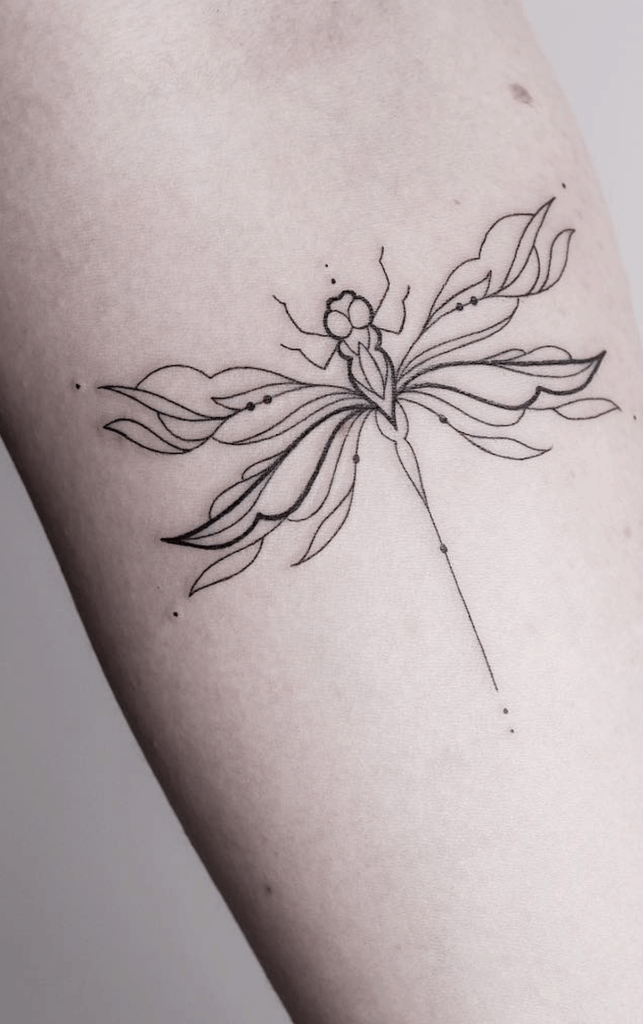 Elegant fine-line dragonfly tattoo with flowing ornamental wings and delicate dot details for a minimalist, artistic look.