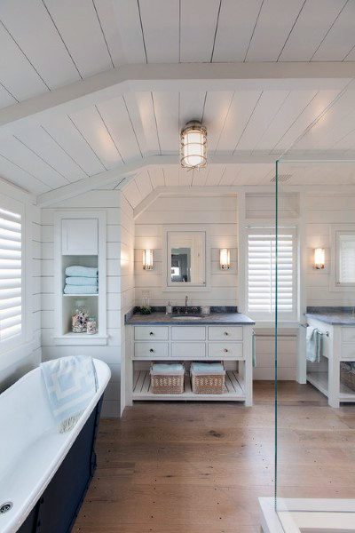 Coastal-style bathroom with shiplap walls and ceiling, freestanding tub, and double vanity.