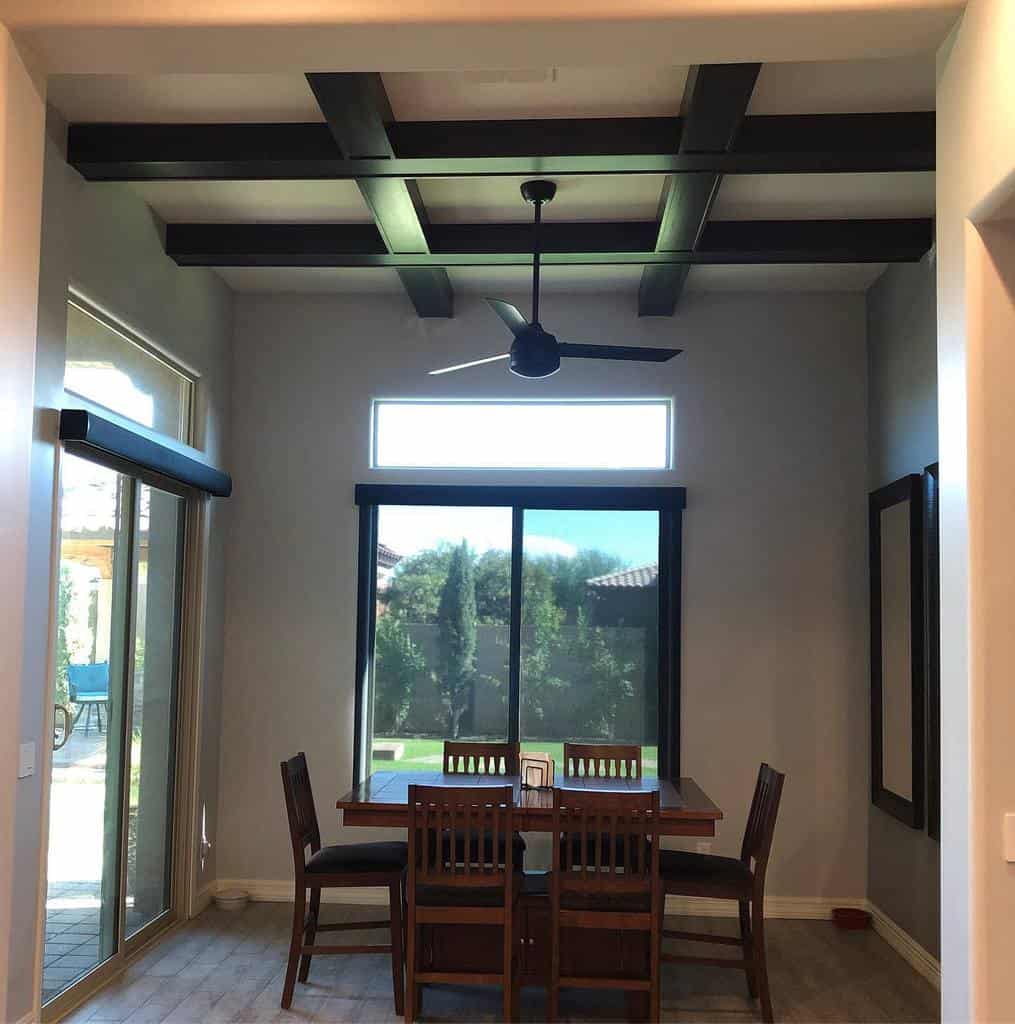 small dining room wood table and chairs exposed beam ceiling fan