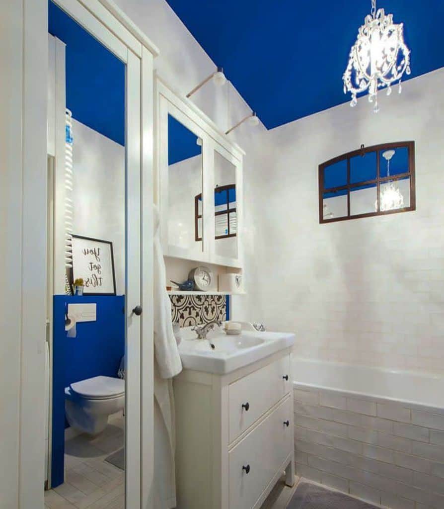 blue ceiling bathroom with white tile walls 