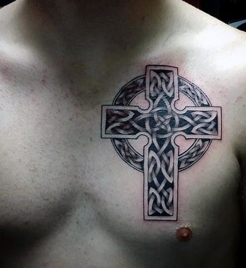 Tattoo of a Celtic cross with intricate knotwork on a chest