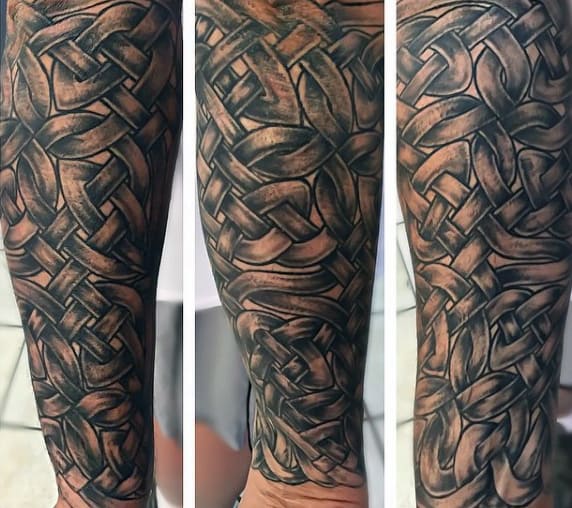 Intricate woven black and grey tattoo sleeve on an arm