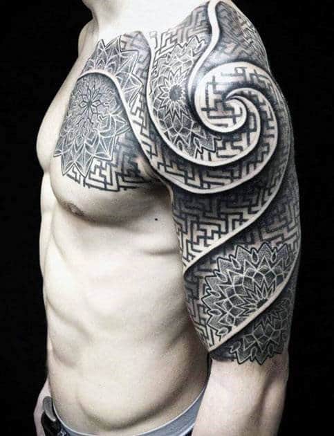 Man with intricate geometric tattoos covering his shoulder and upper arm