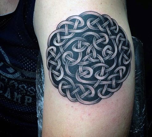 Intricate black and grey Celtic knot tattoo on an upper arm
