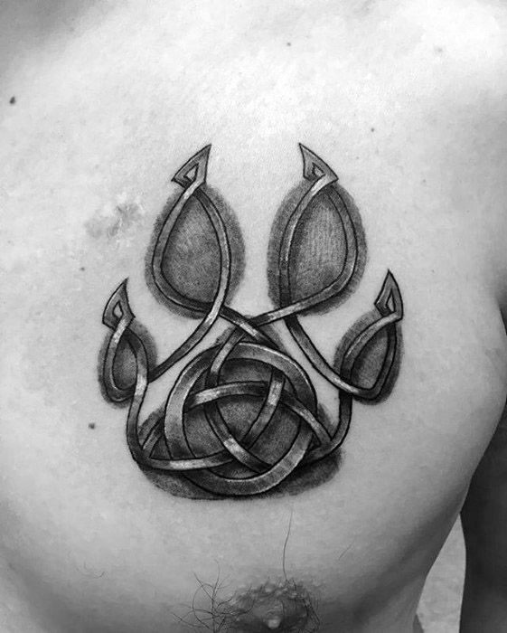 Celtic wolf paw tattoo on chest featuring shaded knotwork forming claws and a central interwoven pattern with bold outlines.