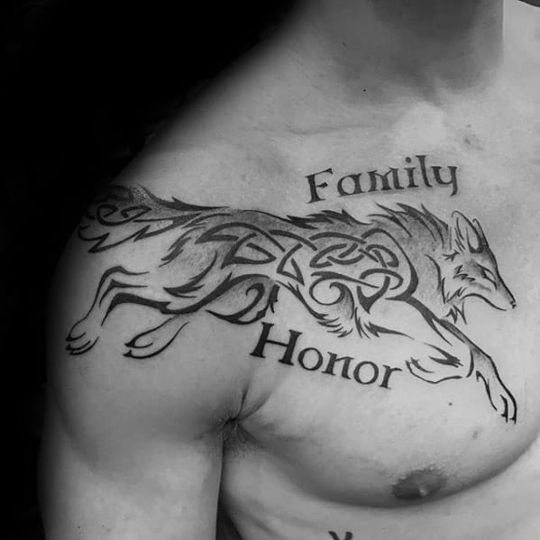 Celtic wolf tattoo on chest showing a leaping wolf with tribal knotwork and the words Family and Honor above and below.