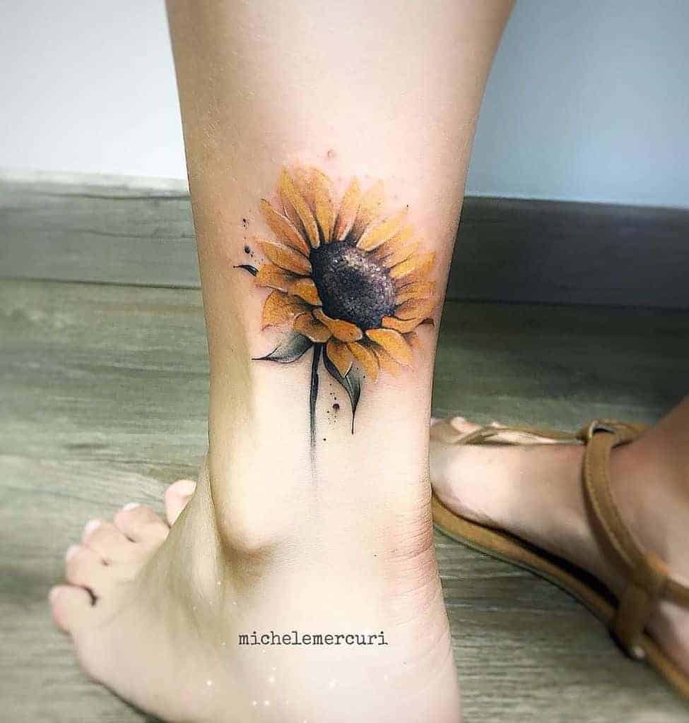 A detailed sunflower tattoo on an ankle