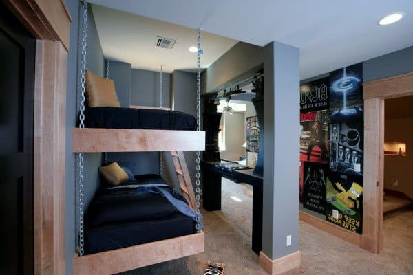 Modern bedroom with bunk beds, dark decor, and a wall adorned with colorful posters