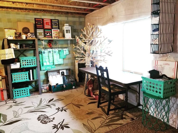 small basement office with desk and chair shelves floral floor rug