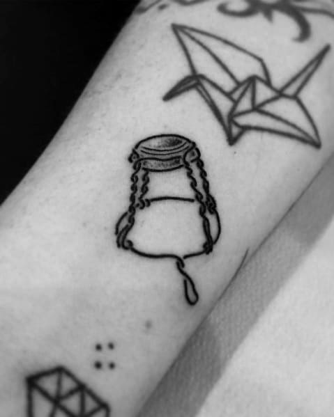 Minimalist tattoo of a champagne wire cage with a dangling loop, inked in fine black lines on the forearm.