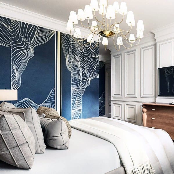 Modern master bedroom with sputnik chandelier, abstract blue wall art, and plush bedding.