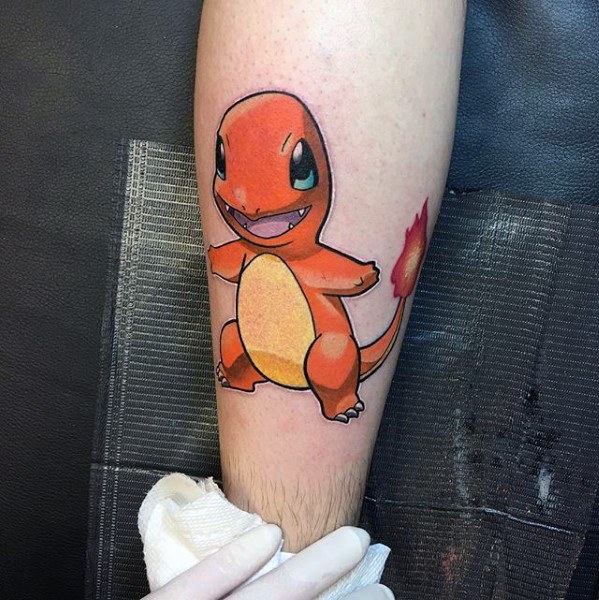 Classic Charmander tattoo on calf with clean outlines, vivid orange shading, and a bright flame on its tail.