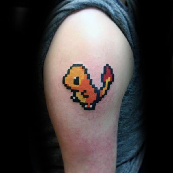 Pixel art Charmander tattoo on upper arm, designed in retro 8-bit style with bold black outlines and classic orange-red coloring.
