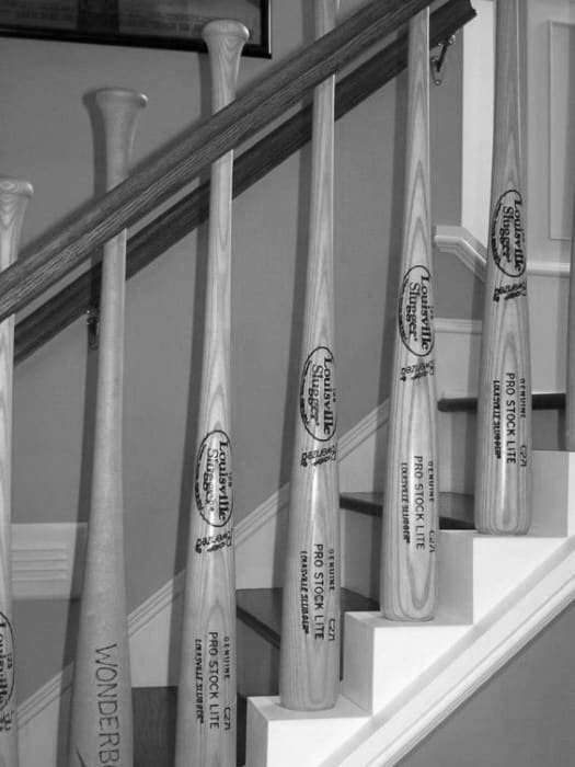Black and white photo of large baseball bats standing upright on a staircase