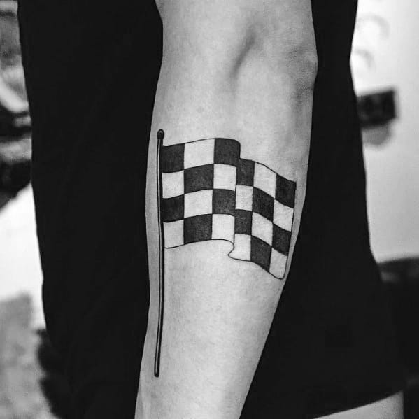 Minimalist checkered flag tattoo on the arm, featuring bold black and white squares, symbolizing racing victory and determination.