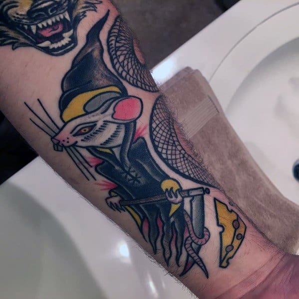 Bold and colorful tattoo of a grim reaper rat holding a scythe, with a wedge of cheese at its feet, featuring neo-traditional style details.